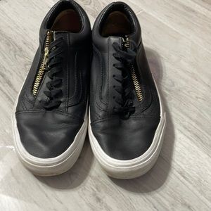Women’s black leather vans with gold zipper